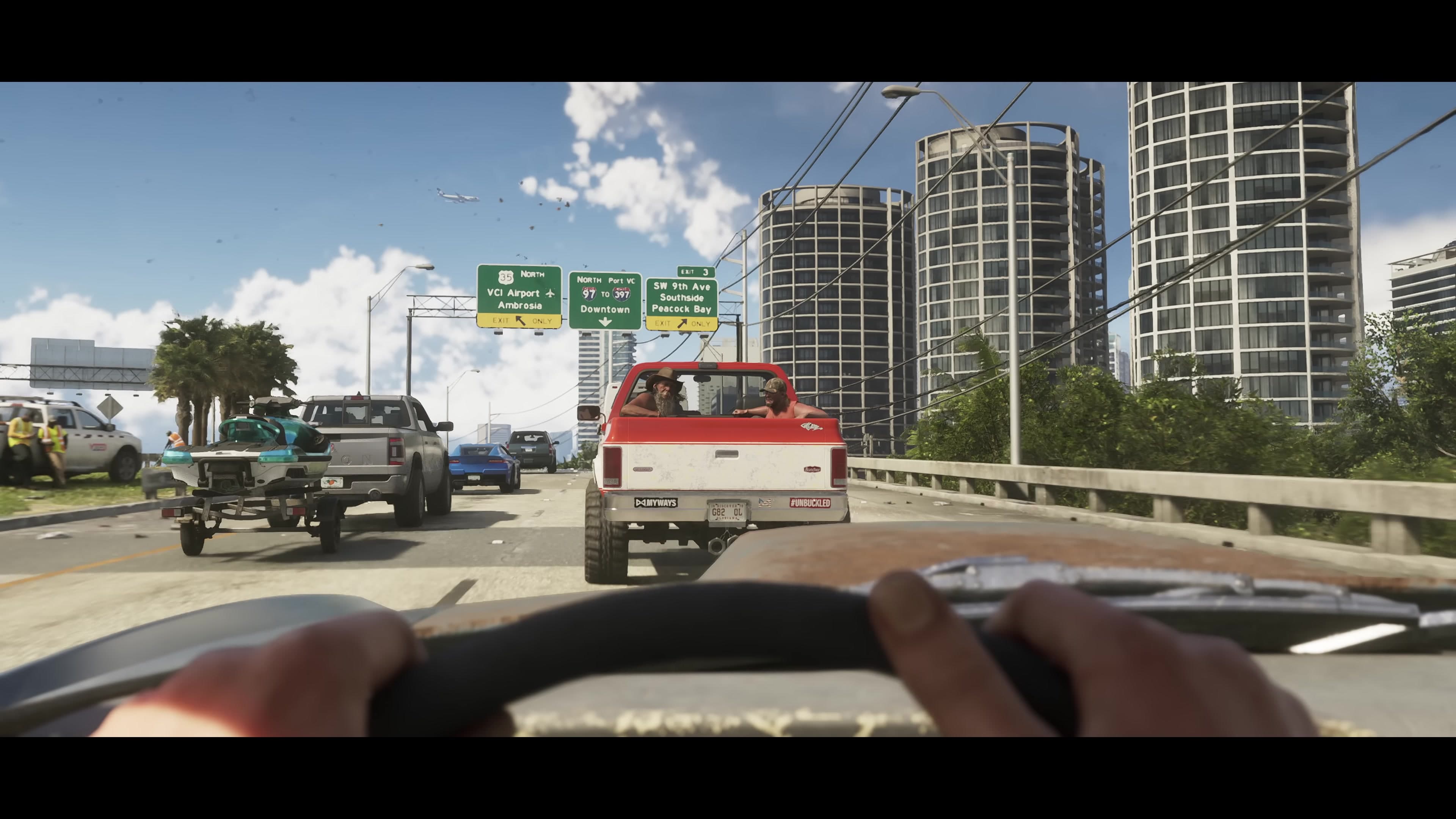 Driving a highway toward the city skyline, plane overhead