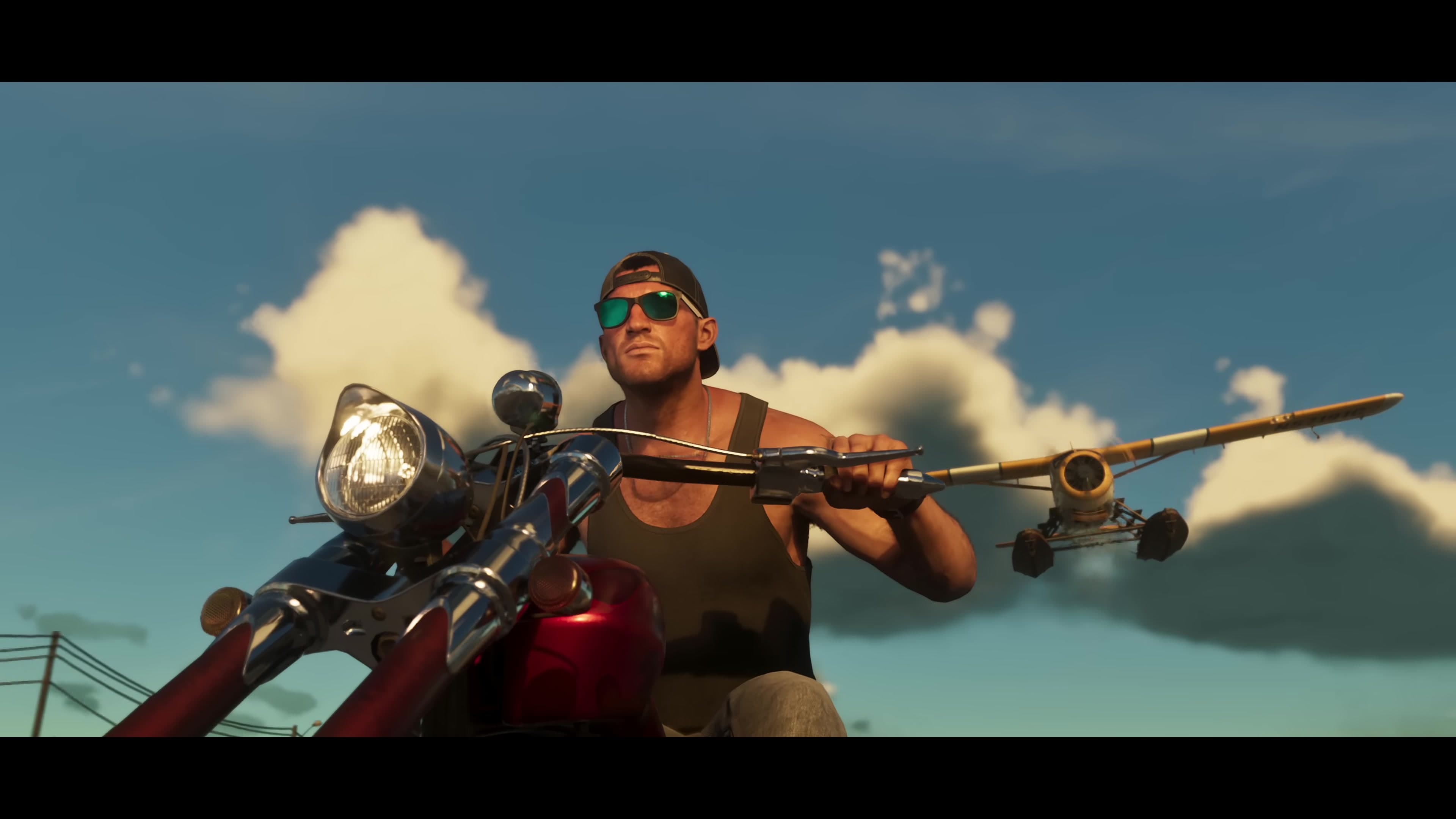 Jason on a motorcycle along the coast, biplane flying low